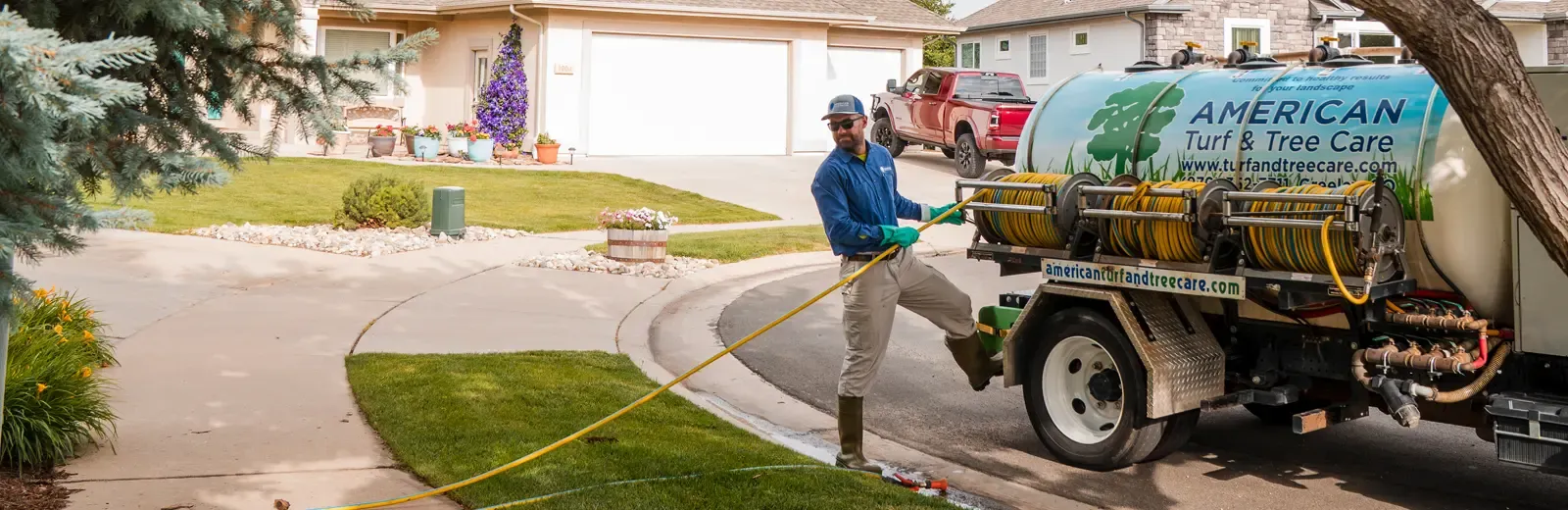 hero-lawn-technician-winding-hose-up