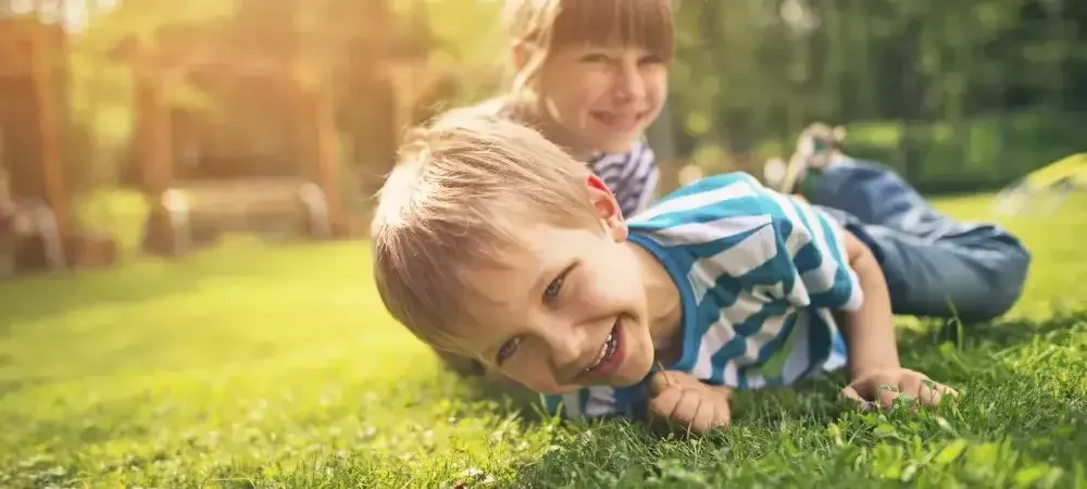 kids playing in green healthy grass