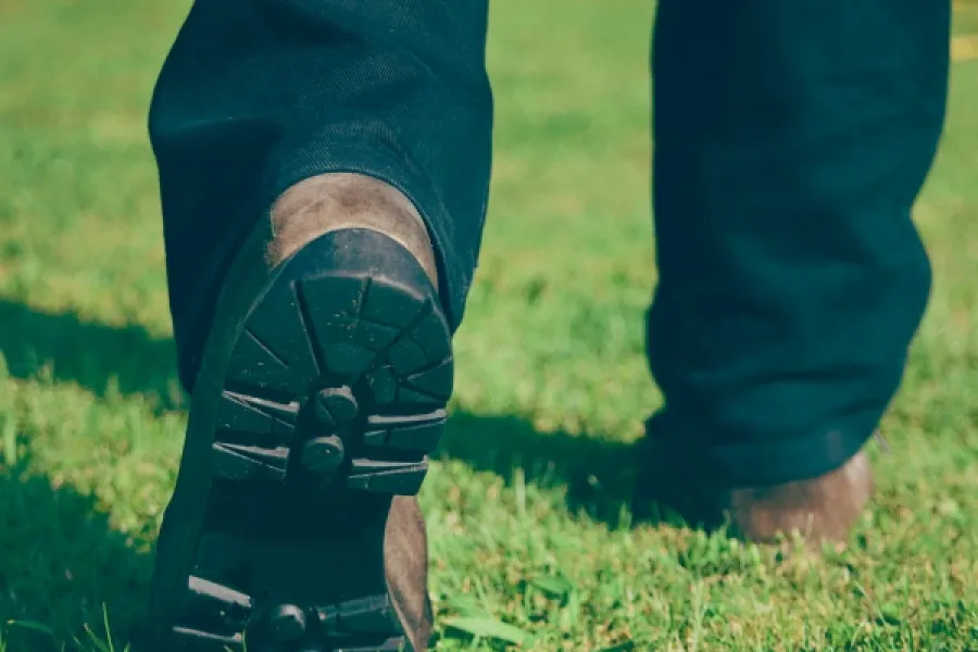 tech walking on grass